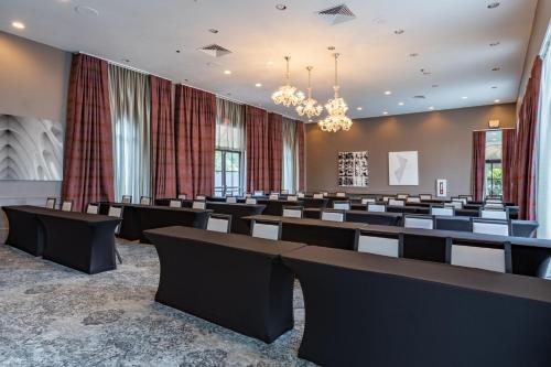a conference room with rows of chairs and a chandelier at Castle Hotel, Autograph Collection in Orlando