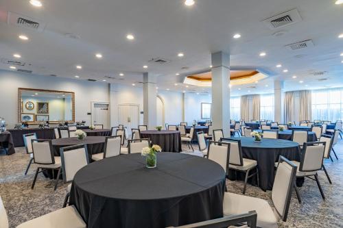 a banquet hall with tables and chairs and a room at Castle Hotel, Autograph Collection in Orlando