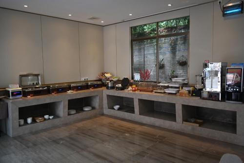 a large room with a counter in the middle at MIZPARTON HOTEL - Heshan Xinhua City Store in Jiangmen