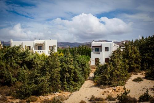 two white buildings in the middle of trees at Villa Alyko in Aliko Beach