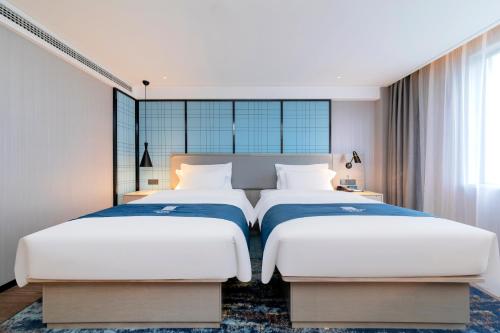 Katil atau katil-katil dalam bilik di Echarm Hotel Guanggu Tiandi