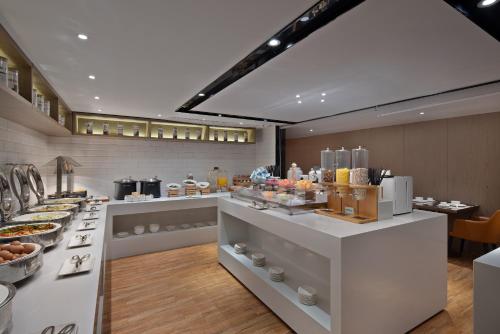 a bakery with a buffet of food on display at Anya Hotel -Next to Jiefang West Bar Street 2 minutes to the subway station free coffee free laundry free gym, huge windows in Changsha
