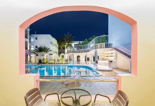 a house with a swimming pool and two chairs at 小鹿辰客觅度设计民宿 in Luoyushangcun