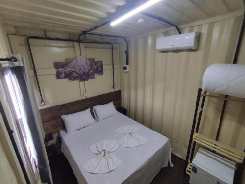 a small bedroom with a bed in a trailer at MOTO Inn URUBICI in Urubici