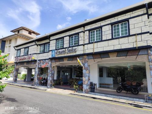 a building with a motorcycle parked in front of it at Ritz Suites in Lumut