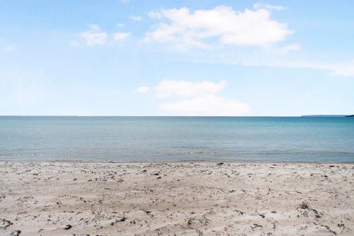 a sandy beach with the ocean in the background at Nice Home In Knebel With 4 Bedrooms And Wifi in Knebel