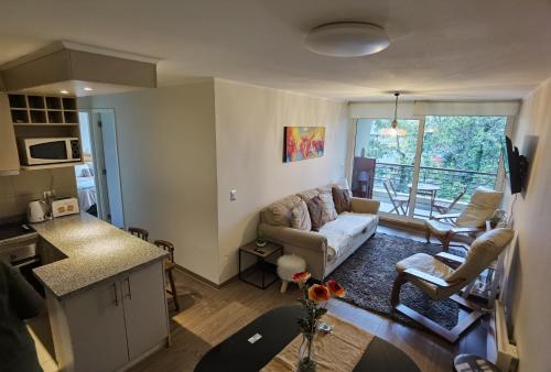 una sala de estar con un sofá y una mesa en Condominio Parque Payllahue, Pucón Camino al Volcán 960, en Pucón