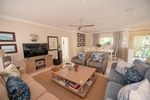a living room with a couch and a table at Lovely 2 bedroom rental unit with exquisite views in Plettenberg Bay