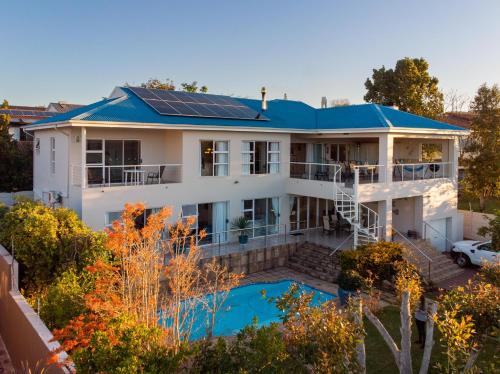 an aerial view of a house with solar panels on the roof at Lovely 2 bedroom rental unit with exquisite views in Plettenberg Bay