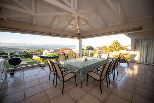 a dining room with a table and chairs at Lovely 2 bedroom rental unit with exquisite views in Plettenberg Bay