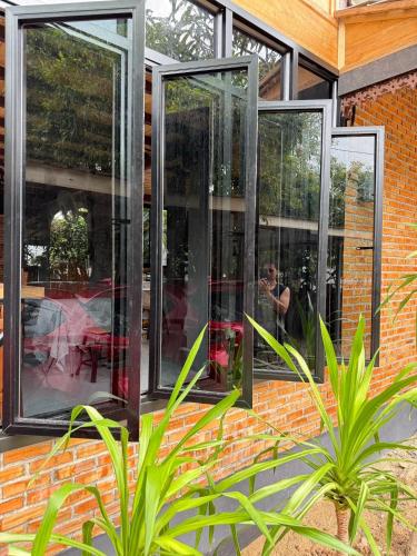 a group of glass windows on a brick building at Lampang Lanna Home in Lampang