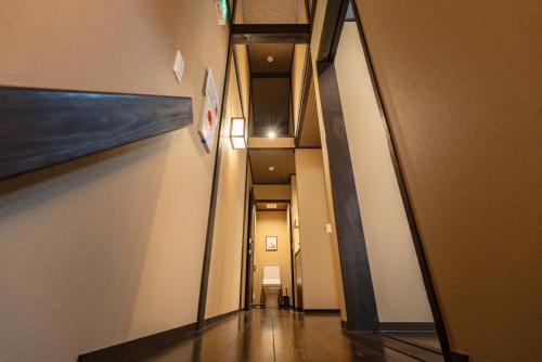 a hallway in a building with a mirror and a painting at 谷町君・星屋・談山旅館　京都嵐山 in Kyoto