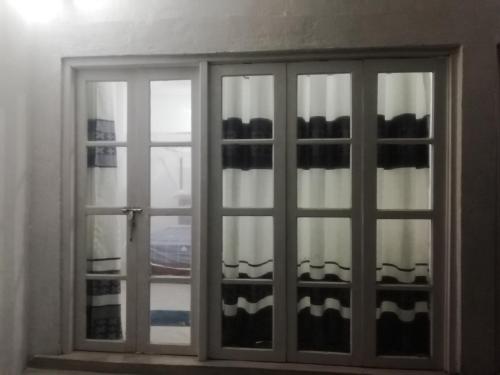a sliding glass window with a view of a city at Kodi Beach Home in Galle