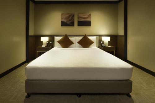Ένα ή περισσότερα κρεβάτια σε δωμάτιο στο Grand Summit Hotel General Santos