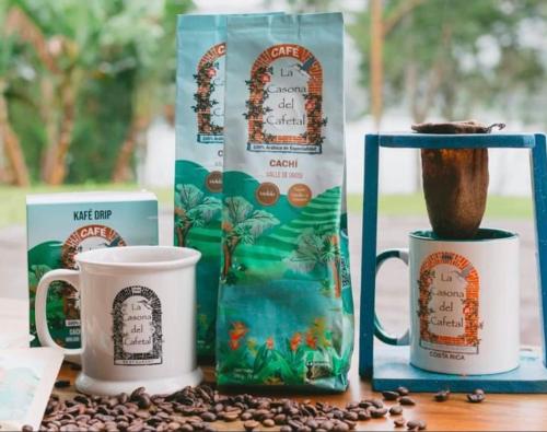 a table with coffee cups and a bag of coffee beans at Hotel Boutique Casona del Cafetal and Lakeside Restaurant in Cachí