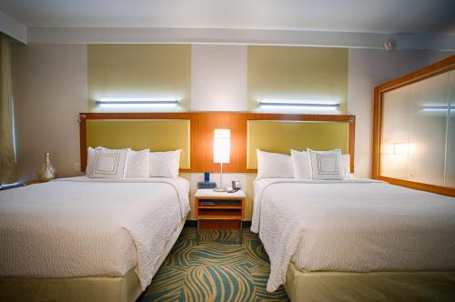 two beds in a hotel room with white sheets at SpringHill Suites by Marriott Canton in North Canton