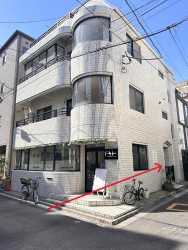 two bikes are parked in front of a building at Kyo Sai 浅草2F浅草寺まで徒步約10分 in Tokyo