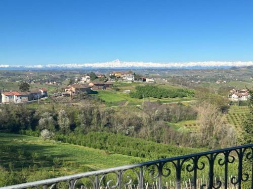 a view from the balcony of a house on a hill at Splendid Villa Magna with Pool and Park - Langhe Hills in Govone