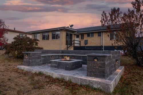 a fire pit in front of a house at Creek View Cottage-pool table, table tennis, views in Stanthorpe
