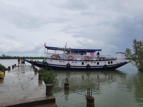 a boat is docked at a dock in the water at M B Sundori in Gosāba