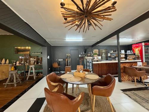 a dining room with a table and chairs and a chandelier at Stanthorpe Holiday Park in Severnlea
