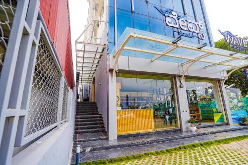 a building with a staircase leading into a store at FabHotel Prime The Waves in Bengaluru