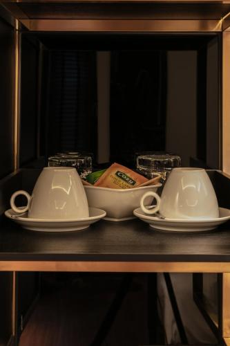 two plates and bowls sitting on a table at Champton Hanoi Hotel in Hanoi