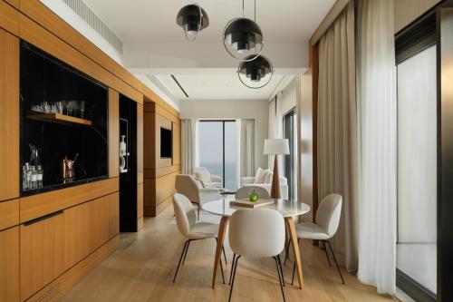 a dining room with a table and chairs at Delano Dubai at Bluewaters in Dubai
