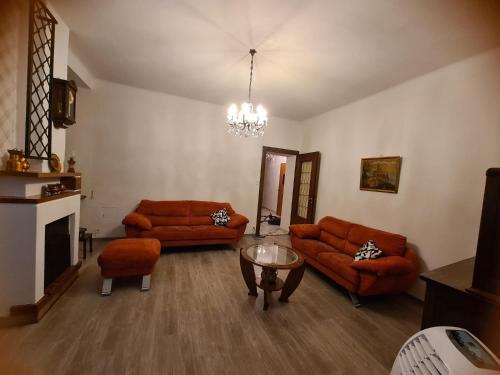 a living room with two couches and a glass table at Tripolitania in Minusio