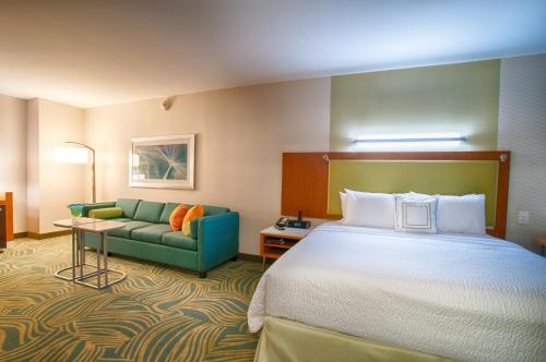 a hotel room with a bed and a couch at SpringHill Suites by Marriott Canton in North Canton