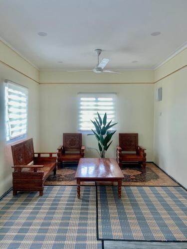 a living room with two chairs and a table at TIARA INN Homestay 2 Tingkat Pontian Johor in Pontian Besar