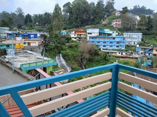 a view of a city from a balcony at Ponmurugan Residency in Kodaikānāl
