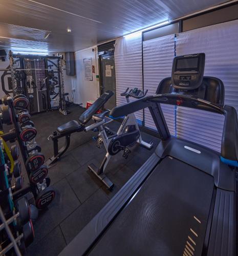 a gym with cardio equipment and a treadmill at Grand Continent Brookefield - A Sarovar Portico Affiliate Hotel in Bengaluru