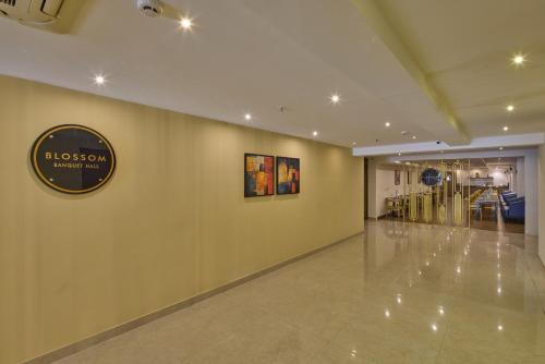 a large hallway with a sign on a wall at Grand Continent Brookefield - A Sarovar Portico Affiliate Hotel in Bengaluru