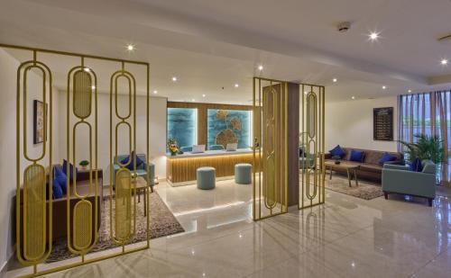 a lobby with a gold door with a couch at Grand Continent Brookefield - A Sarovar Portico Affiliate Hotel in Bengaluru