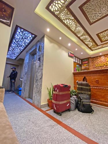 a pile of luggage sitting on the floor in a lobby at Hotel Airport Holiday in Kathmandu