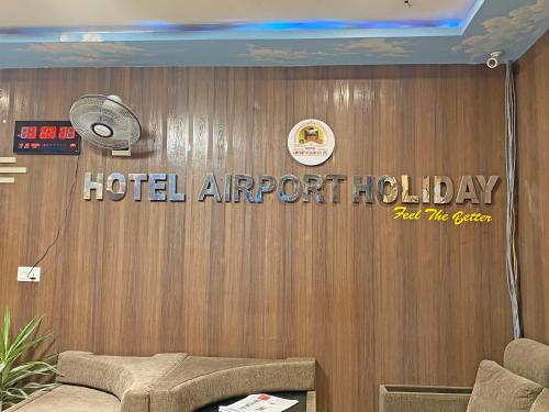 a sign on the wall of a hotel airport lobby at Hotel Airport Holiday in Kathmandu