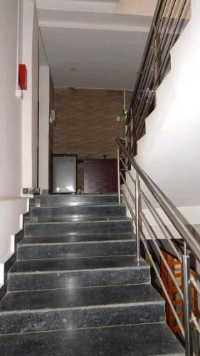 a set of stairs in a building with a television at Shivam Guest House Near GNRC and Down Town Hospital in Dispur