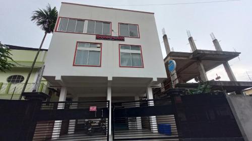 a white building with stairs in front of it at Shivam Guest House Near GNRC and Down Town Hospital in Dispur