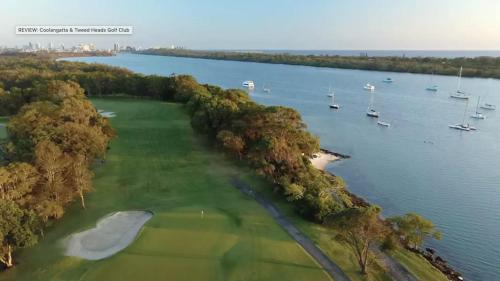 an aerial view of a golf course next to the water at Tweed River Holiday House in Tweed Heads