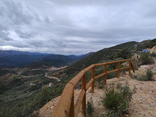a wooden railing on the side of a mountain at ALOJAMIENTO TURISTICO LAS SOLANERAS in Solana del Pino