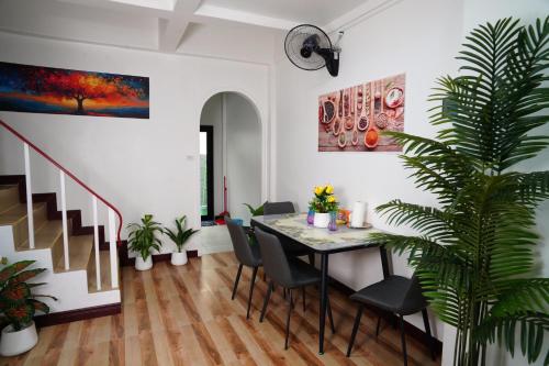 a dining room with a table and chairs at Villa Zuzu Holiday Phuket in Kata Beach