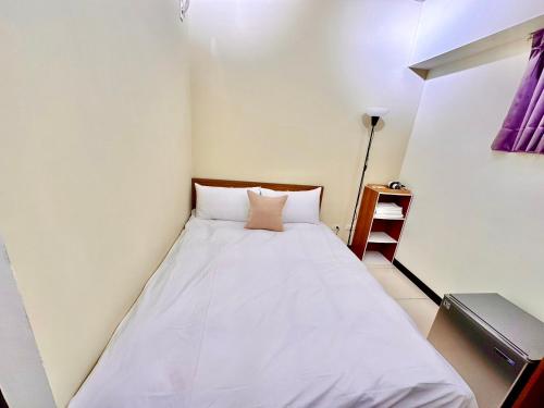 a small bedroom with a bed in a room at 莫蘭狄 in Taichung