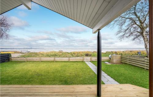 a view from the porch of a house with a lawn at 4 Bedroom Lovely Home In Sjølund in Sjølund