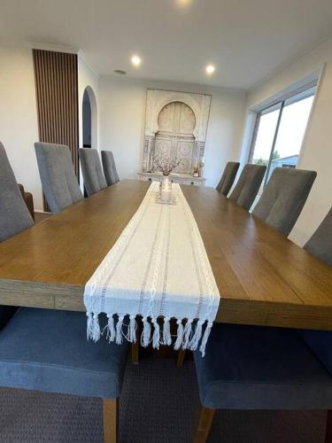a large wooden table with chairs around it at 3 Bedroom House in Cooma in Cooma