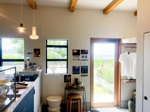 a kitchen with a counter and a door to a yard at HOLLY CAMP CASA in Akagina