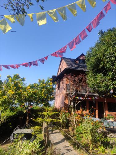 an old house with flags in front of it at Depche Village Resort in Bandīpur