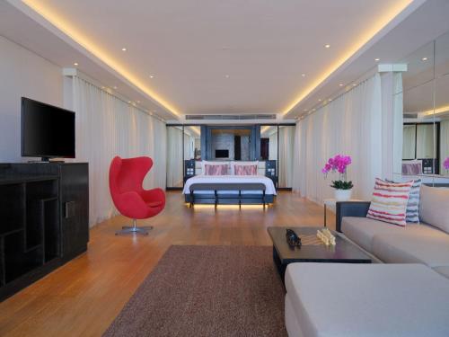 a living room with a couch and a bed in a room at Double - Six, Luxury Hotel - Seminyak in Seminyak