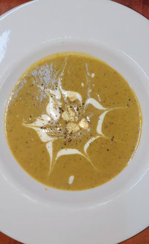 a bowl of broccoli soup on a white plate at Bosch Luys Kloof Nature Reserve in Ladismith