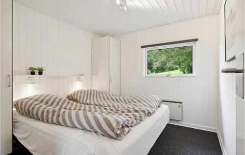 a white room with two beds and a window at Holiday Home Æblehaven Hejls Xi in Hejls